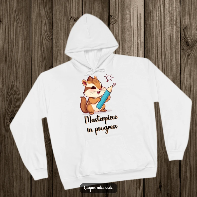 Funny chipmunk hoodie, artistically sketching a silly idea with a giant pencil, looking cozy and creatively inspired.